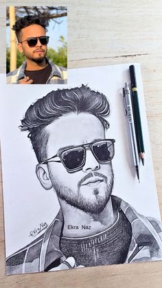 a drawing of a man with sunglasses on top of a piece of paper next to a pen