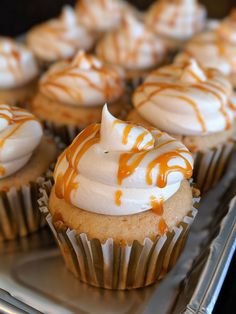 cupcakes with white frosting and caramel drizzled on them