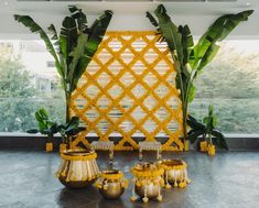 a room with yellow decorations and plants in it