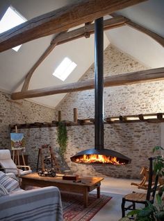 a living room filled with furniture and a fire place in the middle of it's walls