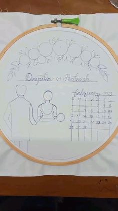 an embroidery pattern on a piece of white paper with a drawing of a man holding a baby