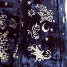 a pair of blue velvet pants with gold stars and crescents on them