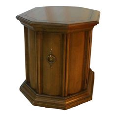 an octagonal wooden table with a door on the top