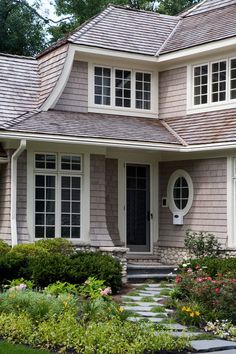 a house that has some flowers in front of it