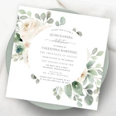 a wedding card with watercolor flowers and greenery