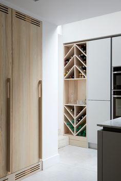 a wine rack in the corner of a kitchen