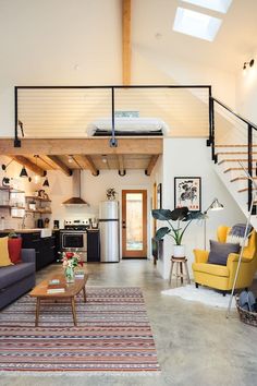 a living room filled with furniture and a stair case