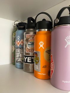 several water bottles lined up on a shelf