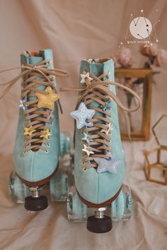 a pair of blue roller skates with gold stars and laces on the top