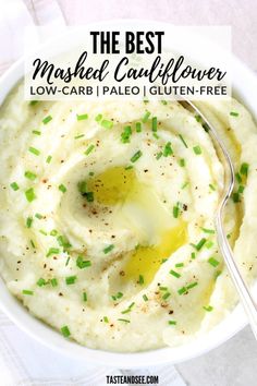 mashed cauliflower in a white bowl topped with green sprinkles