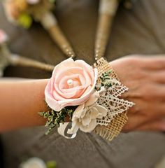 a close up of a person's arm with a flower and lace on it