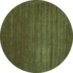 a round rug with an oval design on the top and bottom in shades of green