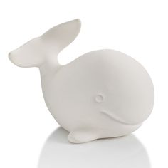 a white ceramic animal sitting on top of a table