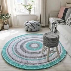 a living room with a white couch and round rugs on the floor in front of a window