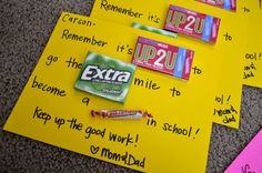 some candy bars are laying on top of post - it notes with the words extra written on them