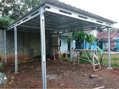 a house with a metal roof in the yard