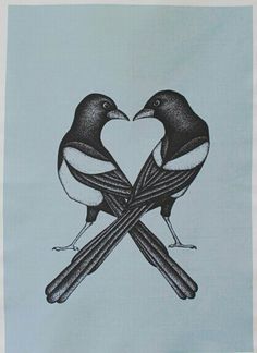 two birds sitting on top of each other in front of a heart shaped piece of paper