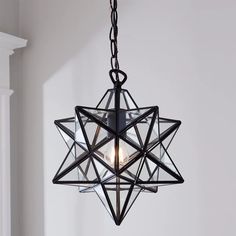 a black chandelier hanging from a ceiling