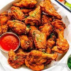 chicken wings with ketchup in a white bowl