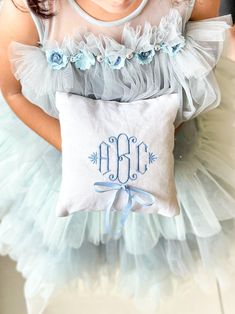 Introducing our exquisite Custom Embroidered Ring Bearer Pillow, a perfect accessory for your special day. This beautifully crafted pillow combines elegance and personalization to create a unique keepsake that will be treasured for years to come. Details of Listed Design: Fabric- White Linen Yarn Color- Aqua Blue Ribbon Color- Light Blue Embroidered Ring bearer pillow to mark the most momentous occassion in ones life. ----------- D E T A I L S ----------- - Fabric Used- 100% Linen or Cotton Sateen Fabric - Ribbon- Comes with a Satin Ribbon of your choice - Filled- The pillow is filled up using poly fill and sealed shut - Size- Multiple sizes available for you to choose ------------------ CARE INSTRUCTIONS ------------------ - Machine Washable - Tumble Dry Low - Iron at cotton heat setting Ring Bearer Holding Pillow, Dog Ring Bearer Pillow, Needlepoint Ring Bearer Pillow, Monogrammed Ring Barrier Pillows, Royal Blue Ring Bearer Pillow, Light Blue Ring Bearer Pillow, Embroidered Ring Bearer Pillow, Ring Bearer Pillows, Ring Bearer Pillow