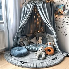 a child's bedroom with a canopy bed and stuffed animals on the floor in front of it