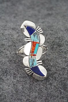 This turquoise, lapis, opalite and sterling silver inlay ring was made by Navajo silversmith James Manygoats. The back is stamped R.B. and .925.Size: 5.5Length: 1 1/2"Width: 1/2"Free shipping on all orders! We ship with USPS and always include tracking. All orders ship within a day of payment.Returns are accepted up to 30 days after you receive your order. Just send us a message. Our shop offers cash back or store credit. The item must be returned in the same condition. Multi Stone, Native American Jewelry, Free Jewelry, Stamp, Turquoise, Sterling Silver, Ring, Stone, Free Shipping