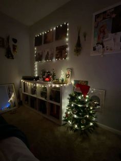 a christmas tree is lit up in the corner of a room with lights on it