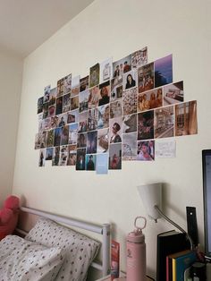 a bedroom with pictures on the wall and a bed in front of a computer monitor