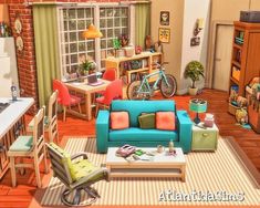 a living room filled with furniture next to a kitchen and dining room table in front of a window