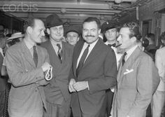 a group of men in suits and ties standing next to each other