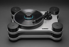 a turntable with two speakers on it and an electronic device attached to the top