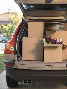 the back of a car with boxes and other items in it