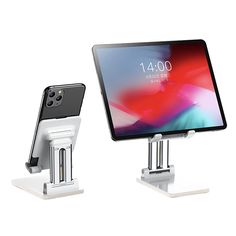 two ipads sitting on stands next to each other in front of a white background