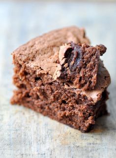 some brownies are sitting on a piece of parchment paper and have been cut into squares