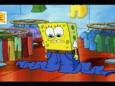 the spongebob is sitting in front of some clothes