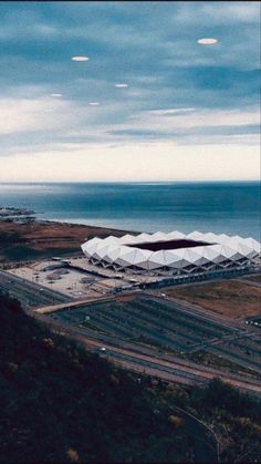 an aerial view of a large building near the ocean