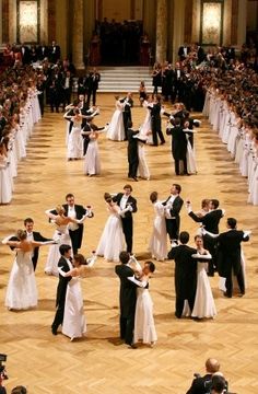 a large group of people in formal dress dancing