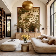 a living room filled with lots of furniture and bookshelves