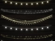 a set of christmas lights and garlands with stars on the strings, isolated against a dark wood background