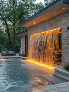 a house with a pool and waterfall in the backyard