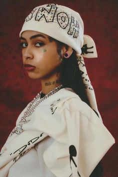 a woman wearing a white hat with writing on it