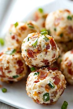 small appetizers with cheese and bacon are on a white plate, ready to be eaten