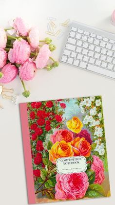 there is a card with flowers on it next to a keyboard and flower bouquets