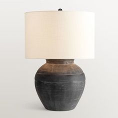 a black and white vase with a light on it