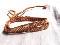 I'd like to present a woolen tablet woven headband which will make a great addition to a viking or medieval costume. This headband will also be perfect for LARP or as a hatband. The product is made to order. The woven part takes about 51 cm / 20", the braided ends are about 28 cm long each. The headband is 1,3 cm wide and made from wool in brownish orange and vanilla color Please note that due to different color adjustment of your and my screens the colors of the band may appear slightly differe Slavic Clothing, Medieval Reenactment, Vanilla Color, Woven Headband, Card Weaving, Tablet Weaving, Medieval Costume, Braids With Weave, Costume Hats