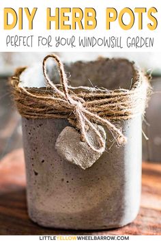 a mason jar filled with dirt and twine on top of a wooden table