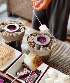 a table topped with desserts and marshmallows