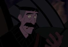 a man with a moustache holding a steering wheel in a car at night