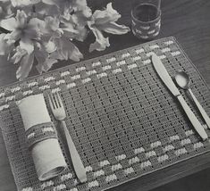 a place mat with utensils and napkins on it