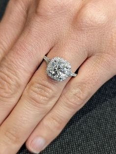 a woman's hand with a diamond ring on her finger and an engagement band